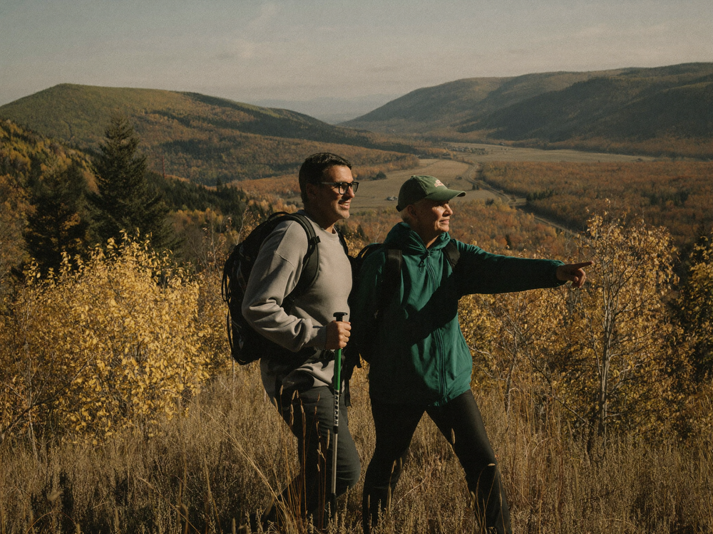 Active couple in their late 50s hiking a ridge trail